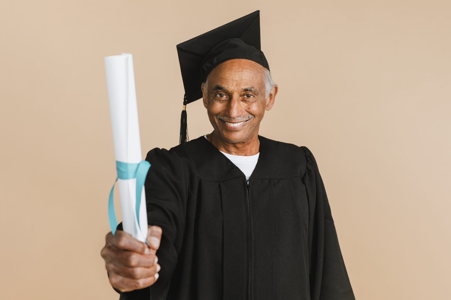 proud senior man in a graduation gown holding his 2022 09 16 07 31 36 utc 1 copy